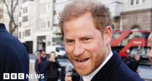Prince Harry bumps into photographer outside court