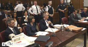 Who was sitting next to Donald Trump in the courtroom?