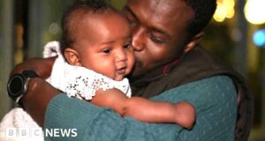 Baby meets father for first time after Sudan escape