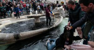 Climate activists dye Spanish Steps fountain water black