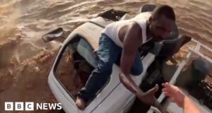 Moment helicopter pulls driver from rushing flood waters